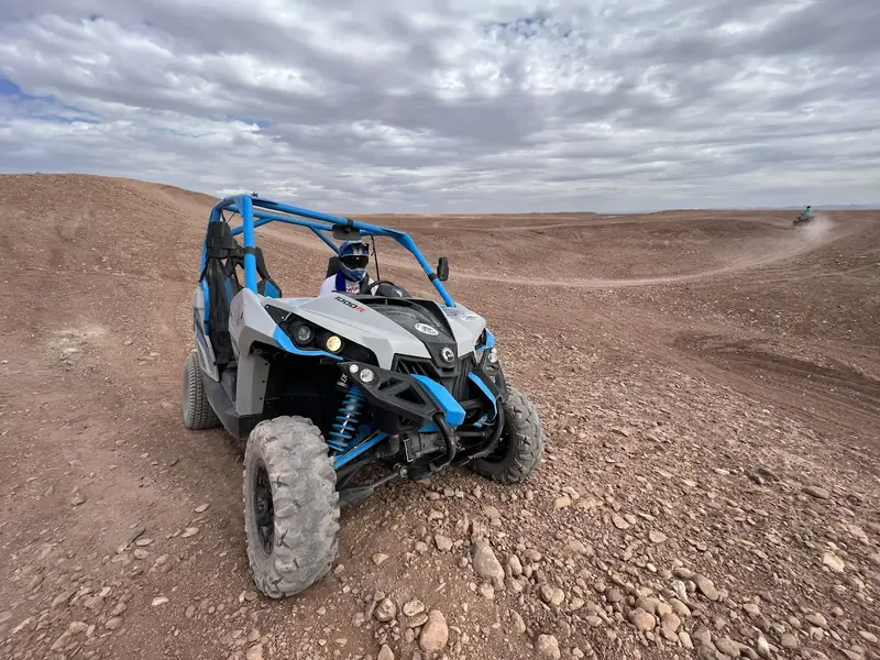 A buggy on the trail toward Ait Ben Haddou under a cloudy sky