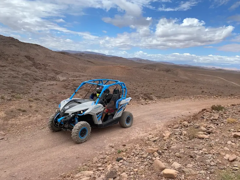 A buggy on a winding track through the hills