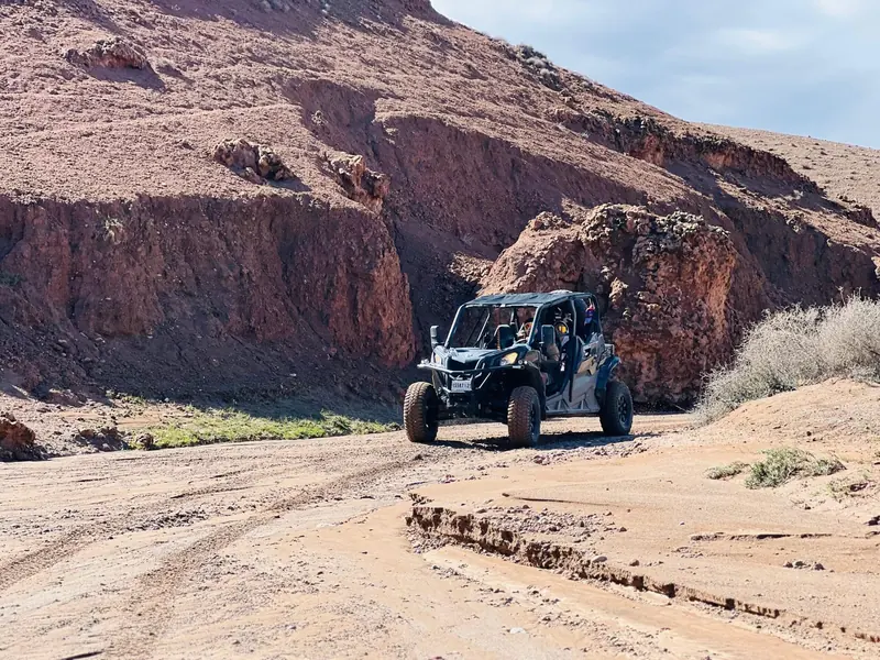 A buggy driving out of a red rock canyon