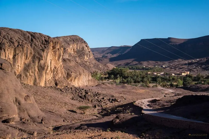 The palm oasis of Fint below rocky cliffs