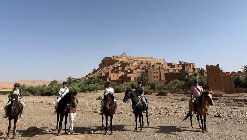 A group of riders in front of Ait Ben Haddou