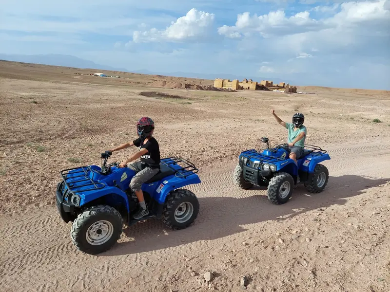 Blue quads on a gravel plain outside Ouarzazate