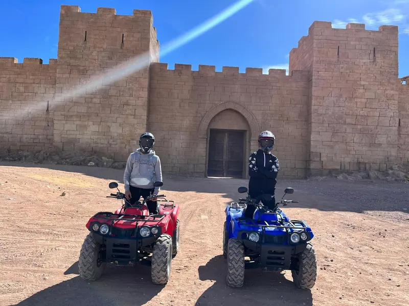 Riders on quads at the gate of the Kingdom of Heaven film set